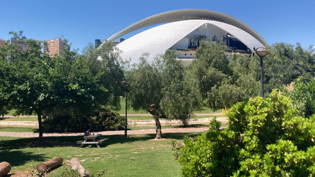 A view of the Reina Sofia opera house from the Turia with a picnic table in the foreground