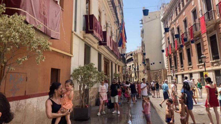 Festival participants dry off after the traditional water fight for Corpus Christi in the historic city center of Valencia