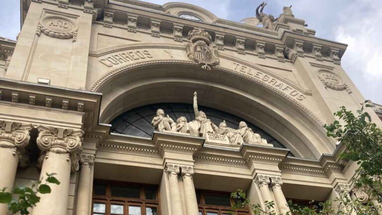 Figures under the arch on the facade of the historic telegraph building in Plaza Ayuntamiento Valencia