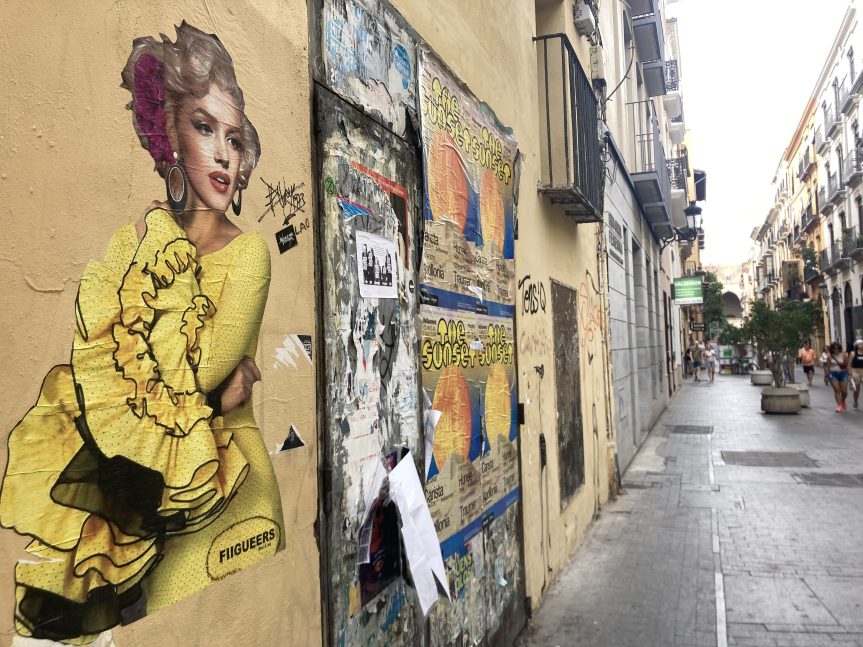 Street art of Marilyn Monroe in a yellow flamenco dress on wall in Valencia's Old City