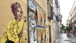 Street art of Marilyn Monroe in a yellow flamenco dress on wall in Valencia's Old City