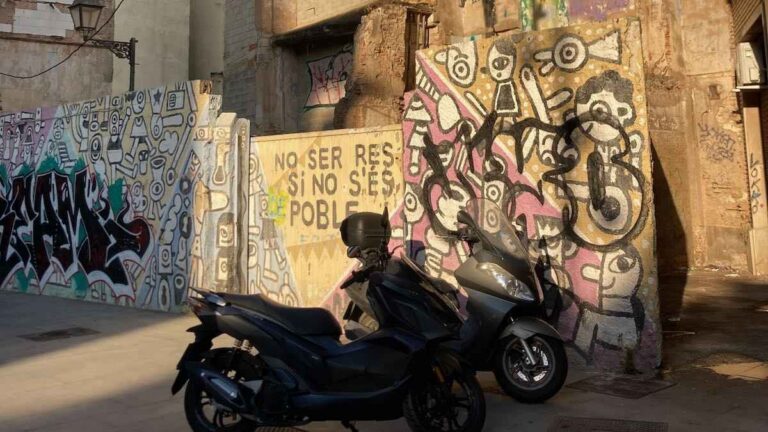 Motorcycle, graffiti and street art in El Carmen protesting lack of housing