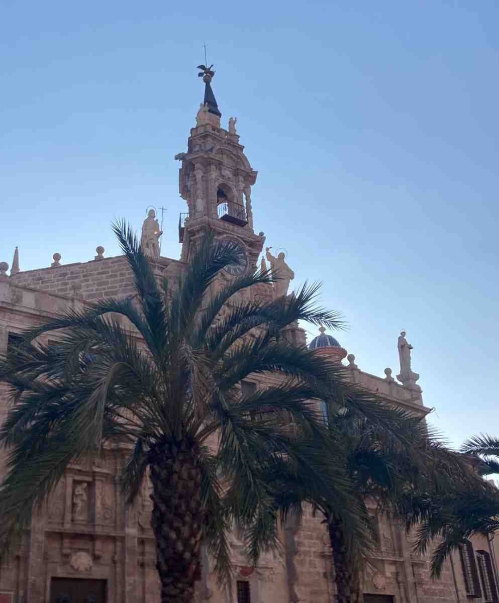 Palm trees framing the roof of the Santos Juanes Church in Valencia