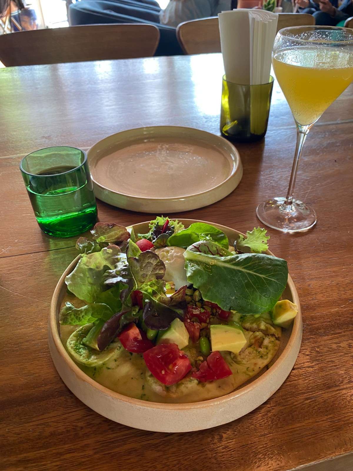 salad and a glass of wine on a table