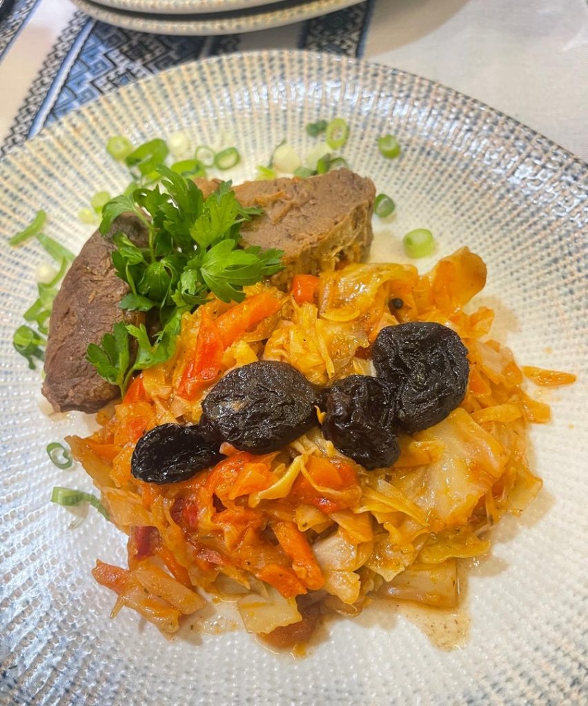 Stewed beef served with cabbage and prunes