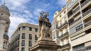 Statue of San Vicente Ferrer in Valencia, Spain surrounded by buildings