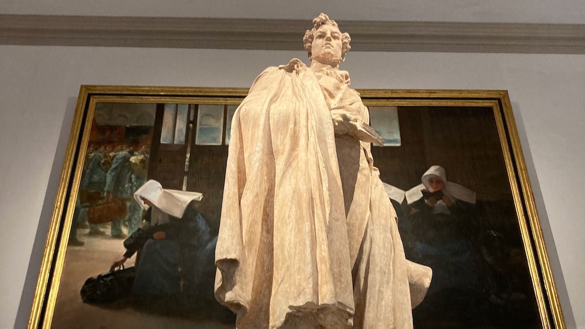 A statue of Duque de Rivas in front of a large art work at the Bellas Artes Museum in Valencia