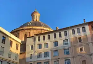 The blue-tiled cupola of the Church of San Joaquin rising over the windows of the Escuelas Pias school.