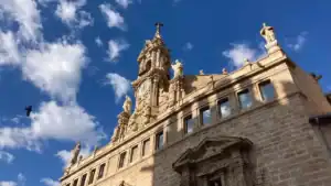 The facade of Santos Juanes church in Valencia with blue sky and clouds