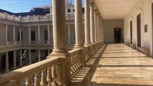 Sun shines brightly on a courtyard corridor inside the University of Valencia's La Nau campus
