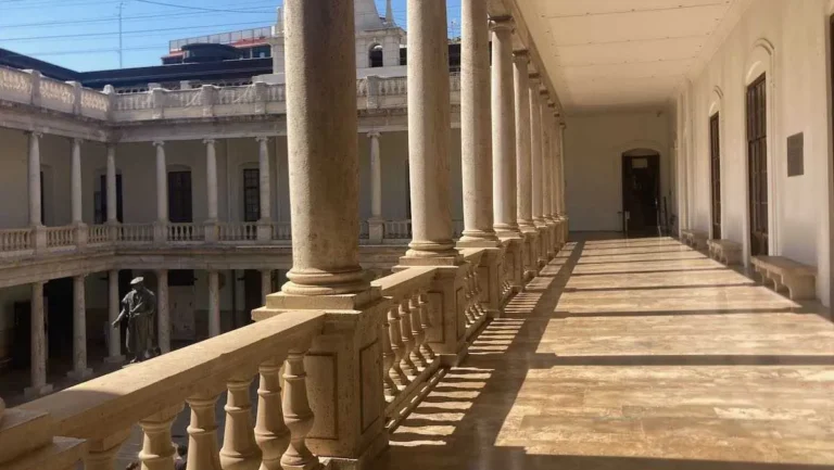 Sun shines brightly on a courtyard corridor inside the University of Valencia's La Nau campus