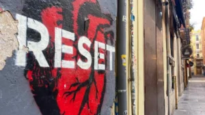 Street art in Valencia's El Carmen neighborhood depicting a red human heart with white stencil lettering that reads "Reset"