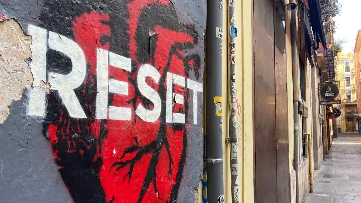 Street art in Valencia's El Carmen neighborhood depicting a red human heart with white stencil lettering that reads "Reset"