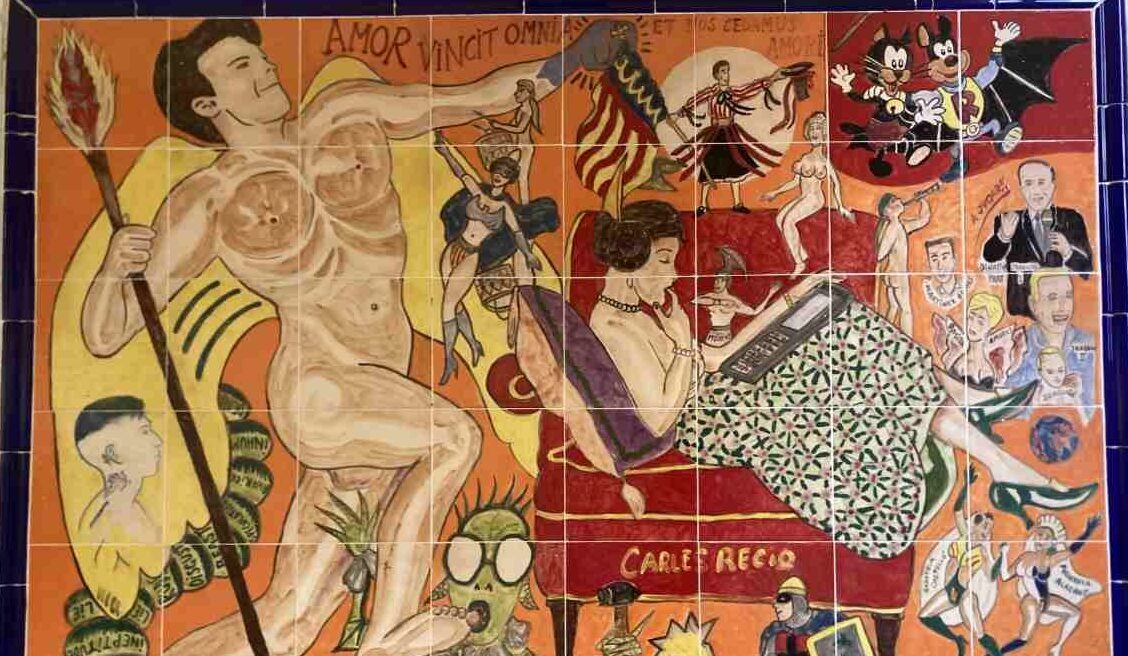 Whimsical ceramic tile painting in El Carmen depicting a near naked man in action as a fallera in traditional Valencian dress reads a book on a chair