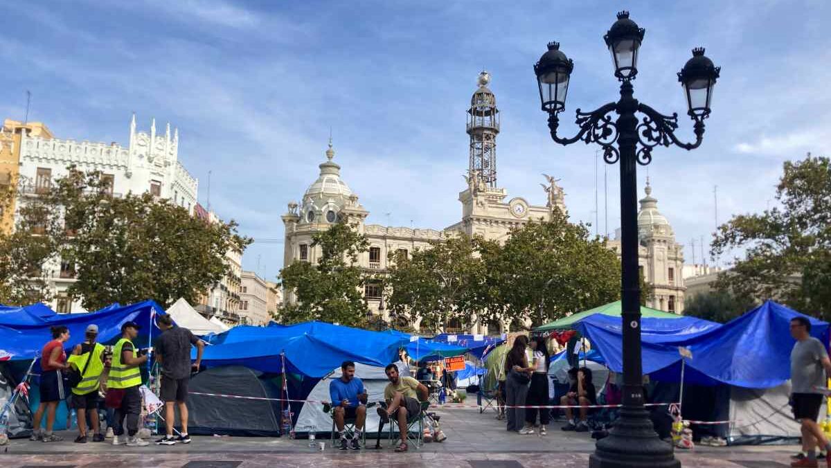 Protesters demanding action on Valencia's housing crisis camp out in blue tents at the Plaza del Ayuntamiento.